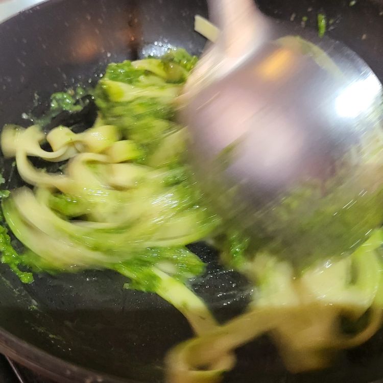Step 3.1: Place your pan onto medium heat, add a large spoon of basil pesto to your pasta & mix well while heating through