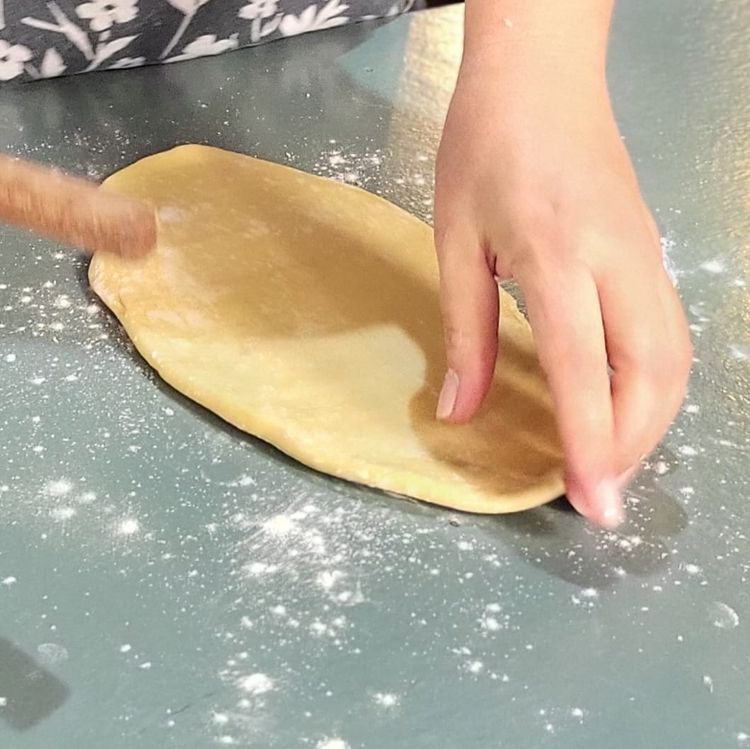 Step 3.1: Get a rolling pin ready, lightly dust the counter with flour, place your dough onto the floured surface, and press flat