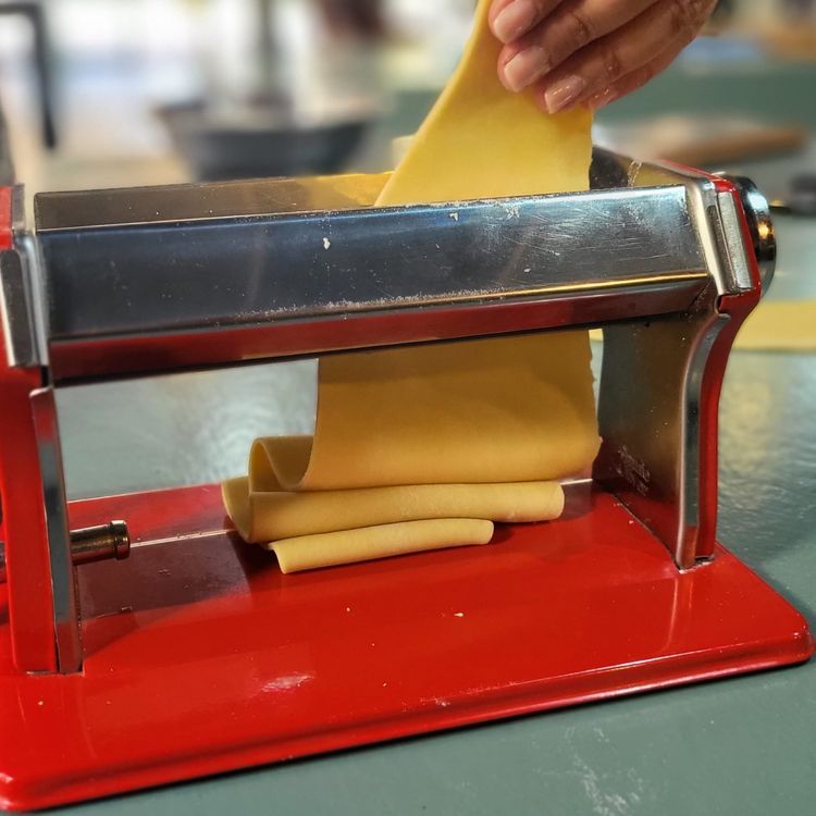 Step 3.1: Take one pasta sheet at a time and feed it through the roller on the wide setting (#5)