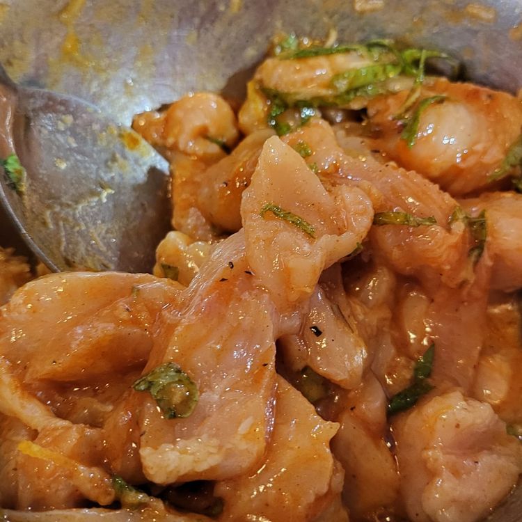 Step 1.2: Place the chicken strips into a bowl and marinate with the lemon juice, zest, garlic, mint, smoked paprika, and half of the olive oil blend