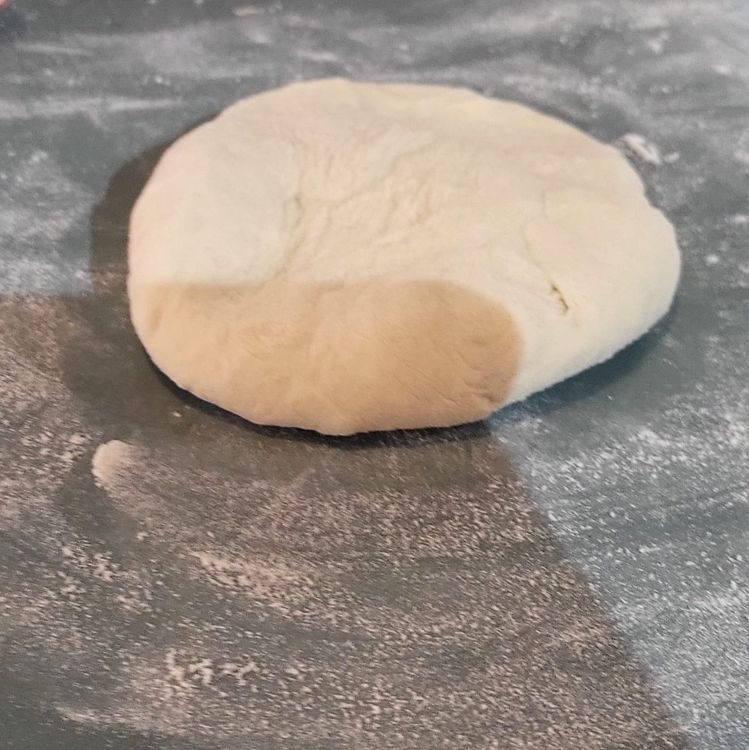 Step 1.1: On a lightly floured surface, push down each dough ball, then roll the dough from the center outwards