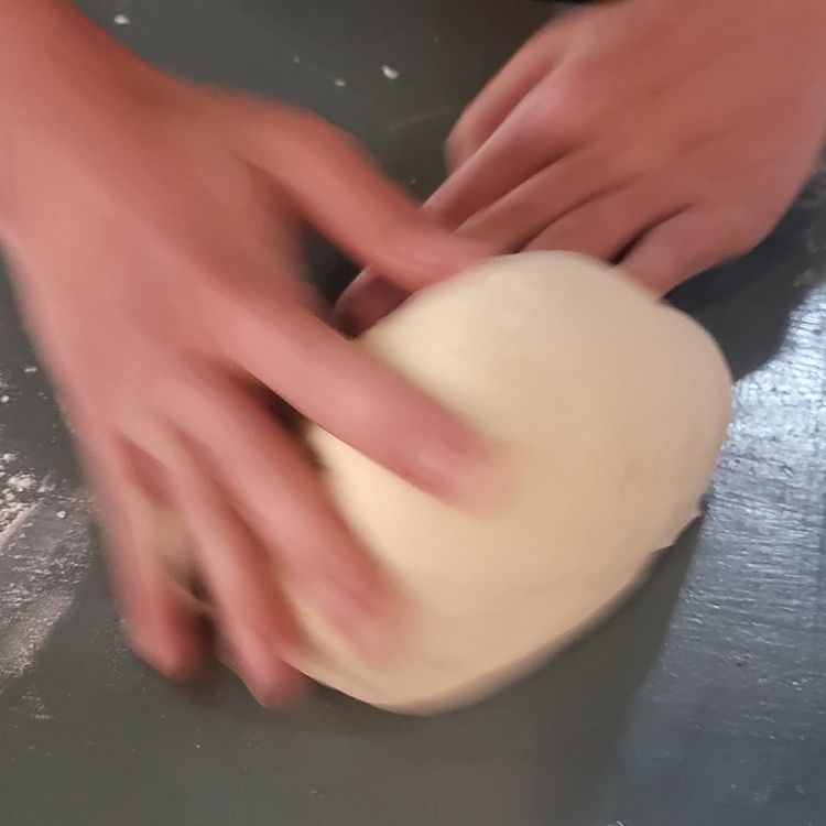 Step 1.1: Place the dough onto a lightly floured surface, then knead with the palms of your hands