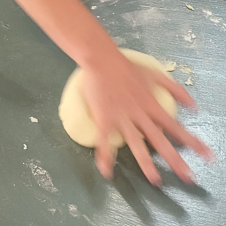 Step 1.2: Place the dough onto a lightly floured surface, then knead with the palms of your hands