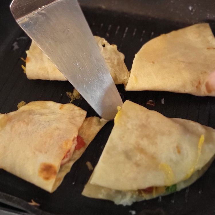 Step 1.1: Heat a griddle pan on low heat, then place your filled quesadillas on the griddle pan and cook until the cheese has melted