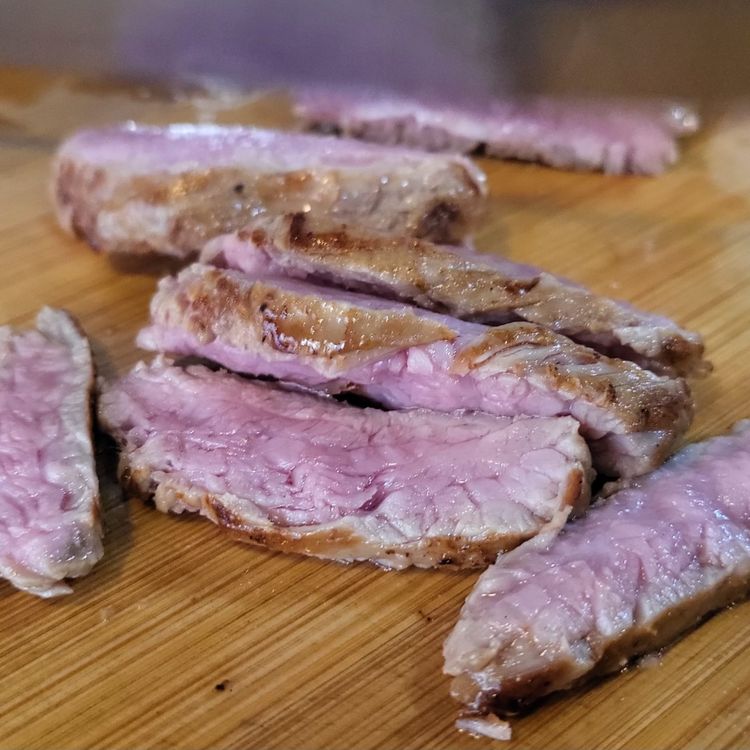 Step 1.1: Slice the steak into thin strips and place on top of each salad