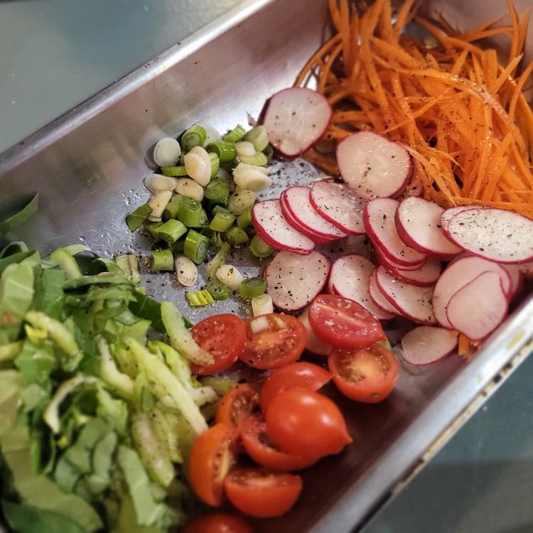 Step 1.1: In the meantime, place your salad ingredients into a mixing bowl: pak choi, tomatoes, spring onions, carrots, and radish