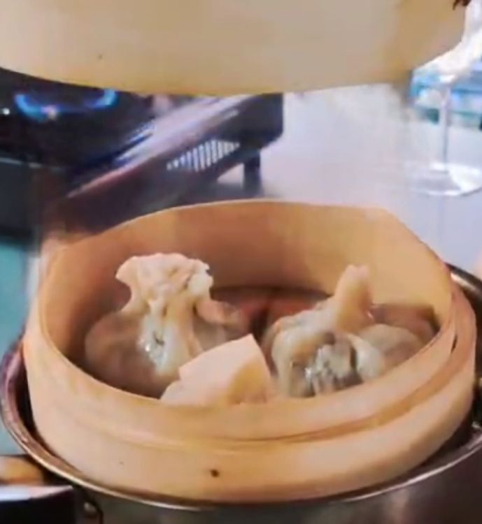 Step 4.1: Bring a small pot of water to boil, place the bamboo steamer on top, and place 3 dumplings into the steamer, ensuring they are not squashed together