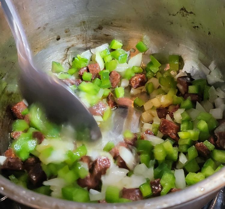 Step 1.2: Heat a medium pot, add the olive oil blend, then add the chorizo sausage & cook over medium to low heat until the oil starts to turn an orange colour