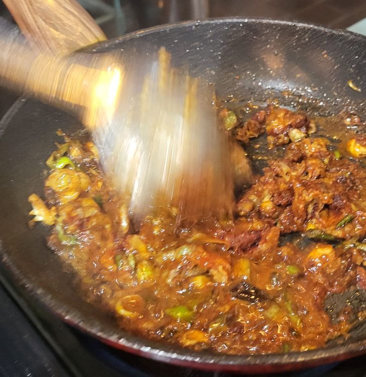 Step 1.4: Heat a wok to medium heat, add the last bit of vegetable oil, then add half of the spring onions