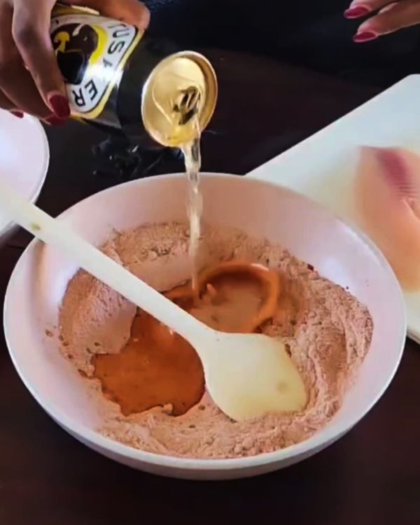 Step 2.1: Slowly add half a can of cold beer to the flour mixture, stirring until smooth