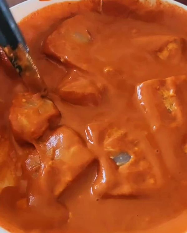 Step 2.1: Dip each piece of the cornstarch-tossed fish into the wet batter, ensuring it's fully coated