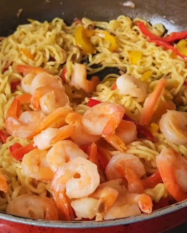 Step 2.1: Add the cooked noodles to the pan, tossing everything together