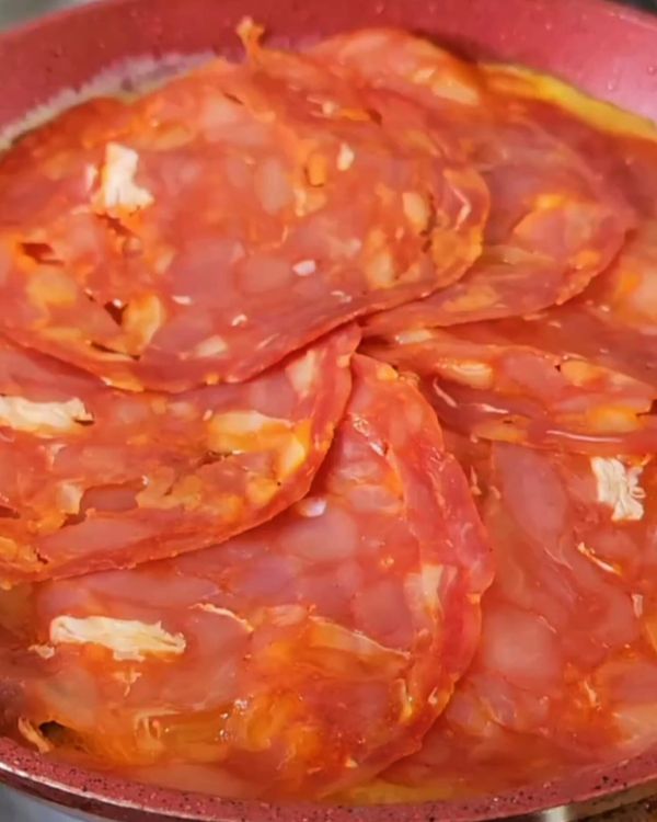 Step 2.1: Lay the salami slices and sprinkle generously with shredded cheddar cheese