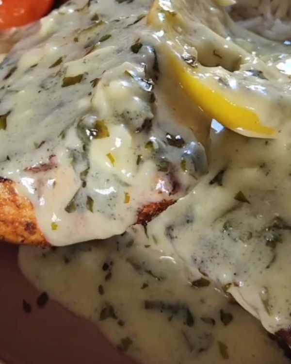 Step 4.1: Place the cooked salmon on a plate and spoon the cream herb sauce over it