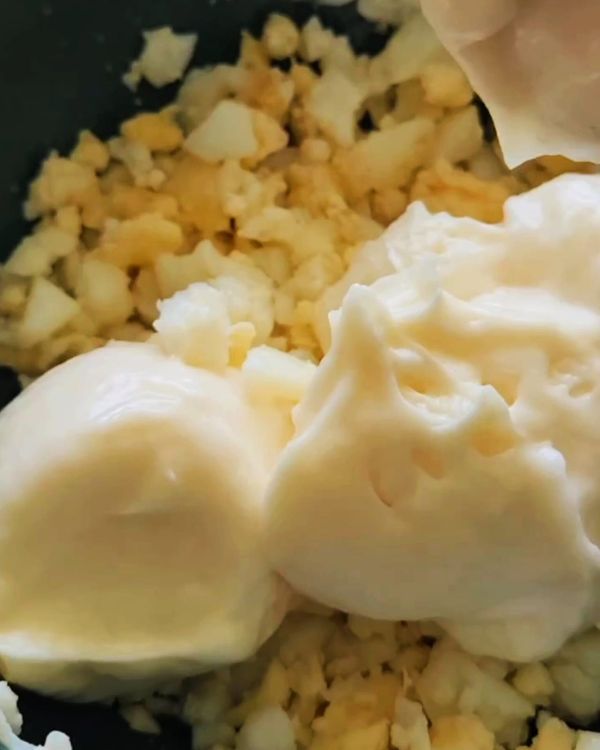 Step 1.1: Mash one of the peeled eggs in a bowl with a fork until slightly chunky