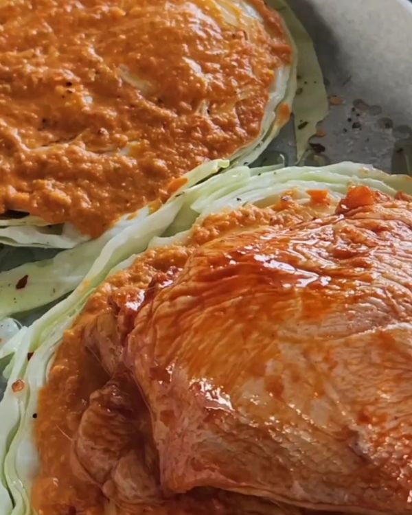 Step 4.1: Place a marinated chicken thigh on top of each cabbage steak