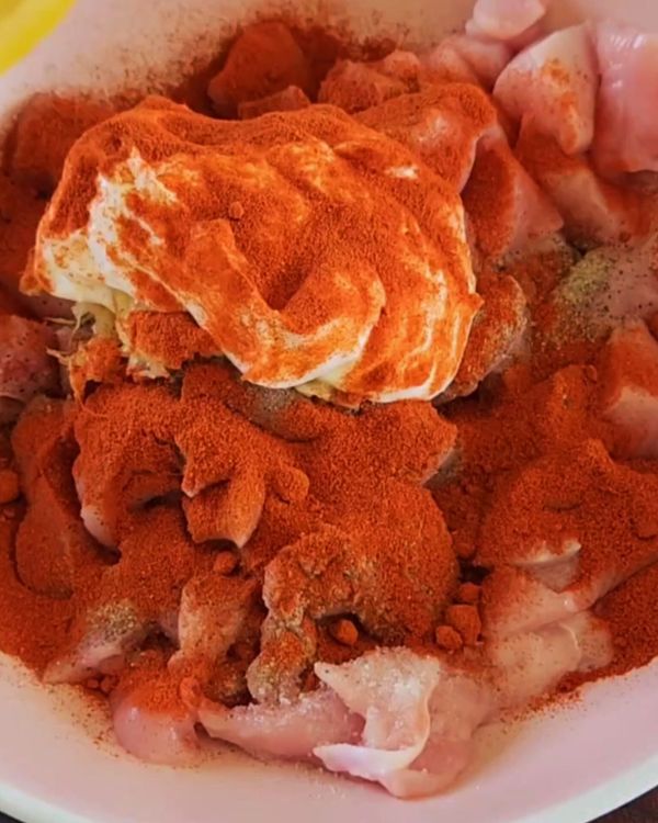 Step 1.1: In a bowl, combine the chicken chunks with lemon juice, paprika or chili powder, crushed garlic and ginger, Greek yogurt, salt, and pepper