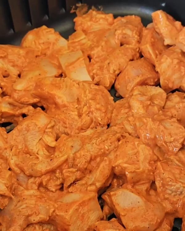 Step 1.2: In a bowl, combine the chicken chunks with lemon juice, paprika or chili powder, crushed garlic and ginger, Greek yogurt, salt, and pepper