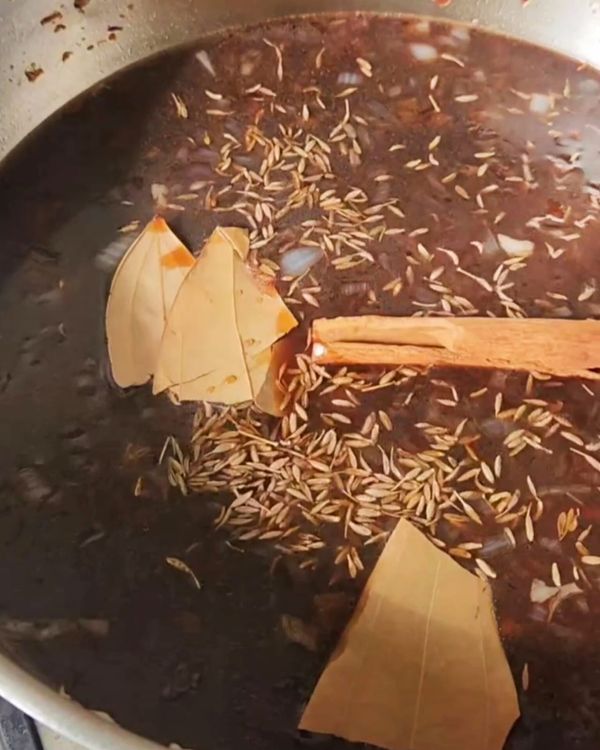 Step 3.1: In the same pan, add the Chinese 5-Spice powder, light and dark soy sauce, brown sugar, bay leaves, cinnamon stick, and water or chicken stock