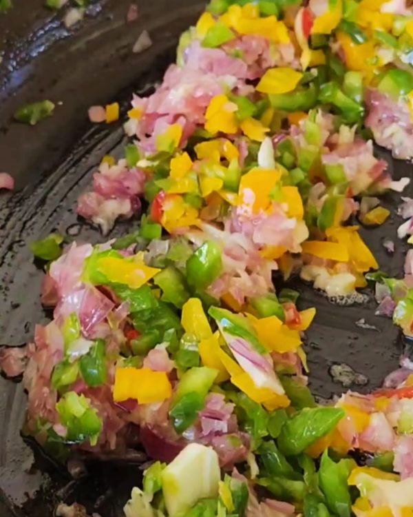 Step 1.1: Stir in the crushed garlic, diced green and yellow peppers, and cook until the peppers soften, about 3-4 minutes