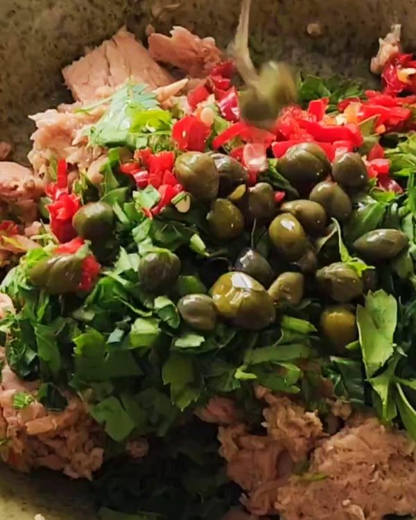 Step 1.1: Add the chopped parsley or coriander and capers, then mix to combine