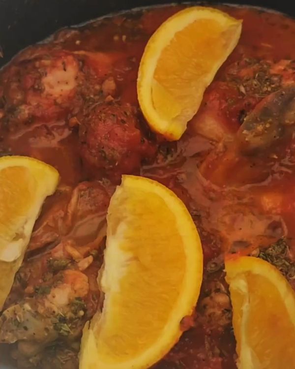 Step 3.1: Pour in the canned pomodoro tomatoes, dried oregano, bird’s eye chili, and the quartered orange pieces