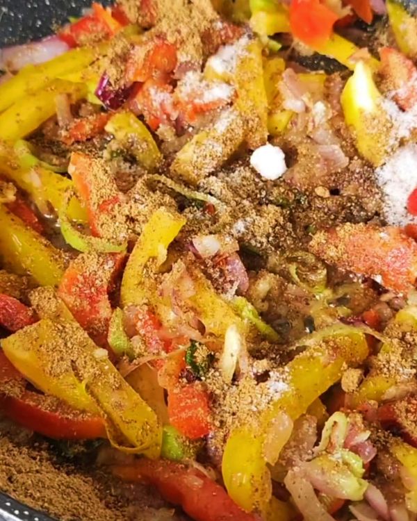 Step 2.1: Stir in the grated or crushed tomatoes, bell peppers, turmeric powder, curry powder, and chili flakes (if using)