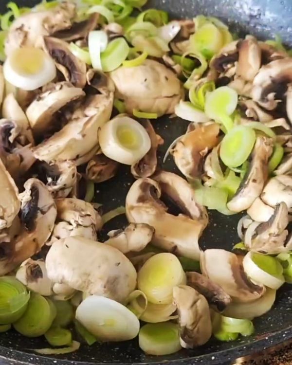 Step 2.1: In the same skillet, add the sliced leeks and mushrooms, cooking until soft and fragrant