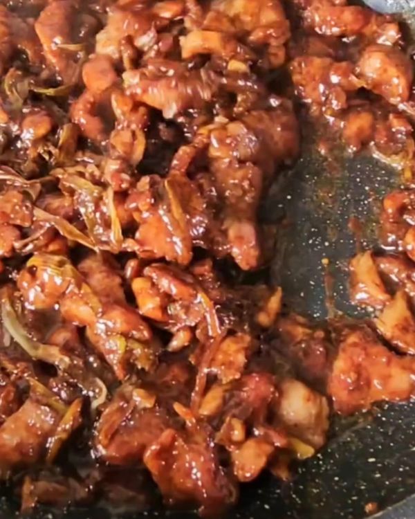 Step 5.2: Add the spring onions and red pepper strips, and stir-fry for another 1-2 minutes until the vegetables are just tender