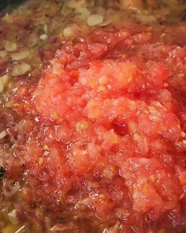 Step 2.1: Add the grated tomatoes and cook for another 3-4 minutes until the sauce starts to thicken slightly