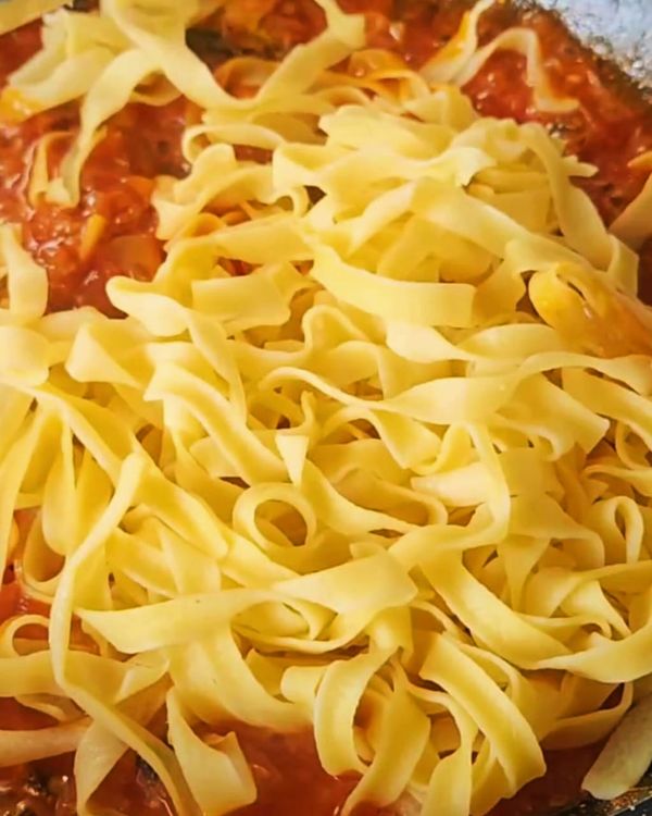 Step 4.1: Toss the cooked pasta into the sardine tomato sauce, mixing well to coat the pasta