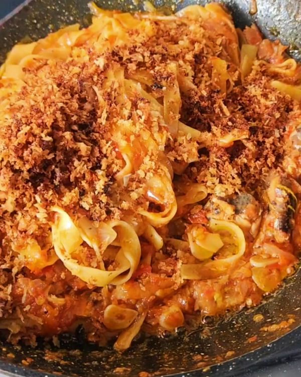 Step 4.2: Toss the cooked pasta into the sardine tomato sauce, mixing well to coat the pasta