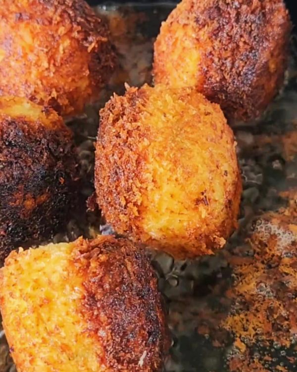 Step 4.1: Once hot, carefully add the potato balls in batches, frying until golden brown and crispy on all sides, about 2-3 minutes
