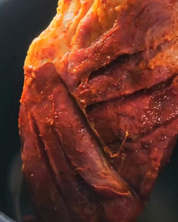 Step 1.1: Place the seasoned goat leg in the pressure cooker