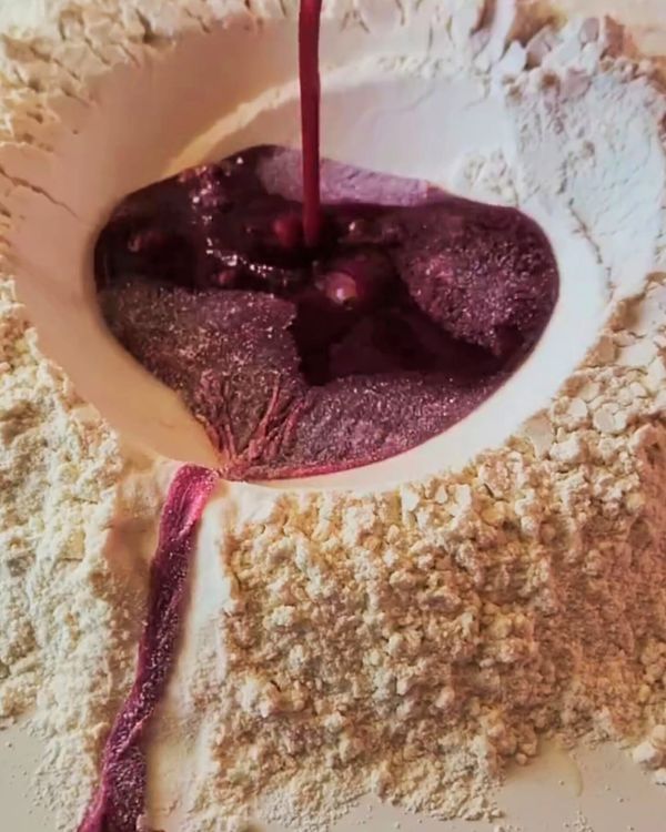 Step 1.1: Use a fork to whisk the eggs and beet juice, gradually incorporating the flour from the edges of the well