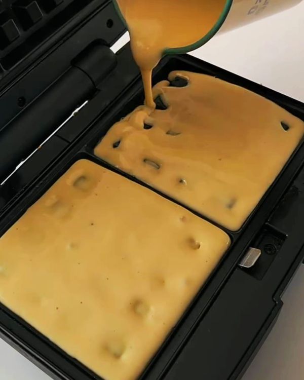 Step 2.1: Pour the batter into the trays, close, and cook for 8–10 minutes or until golden and crisp