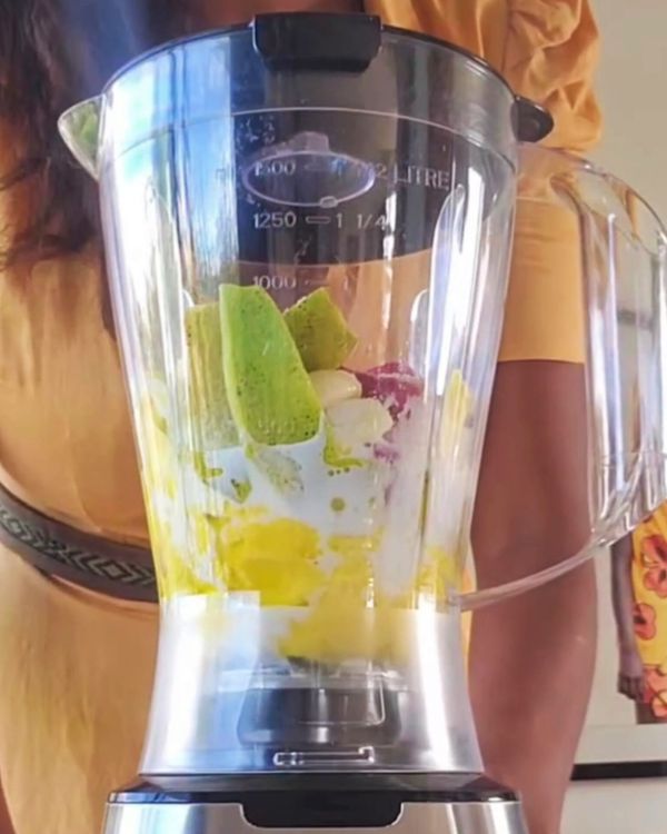 Step 1.1: Add the mango (with peel), coconut milk, onion, garlic, ginger, chilies (if using), lemon juice, oregano, salt, and pepper to a blender