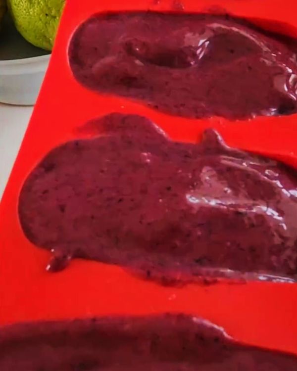 Step 2.1: Spoon the blueberry sorbet mixture into popsicle molds, smoothing the tops for an even finish