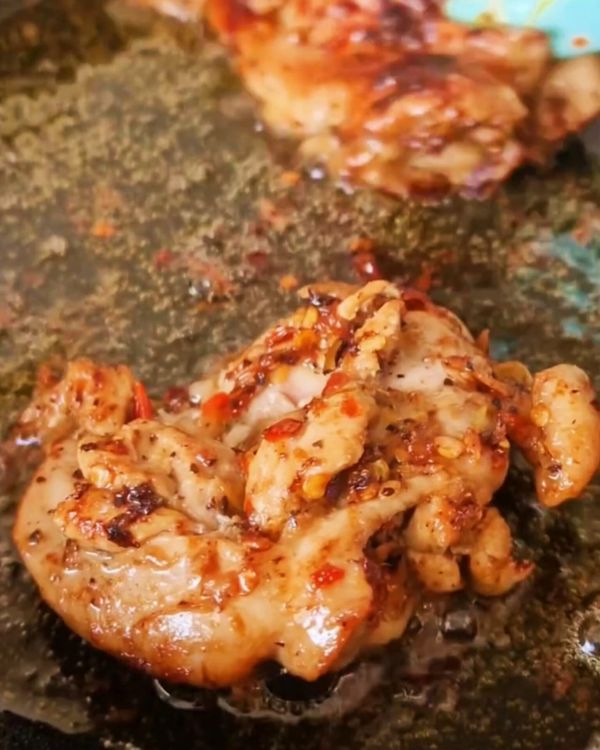 Step 2.1: Once hot, add the marinated chicken thighs, skin-side down if applicable