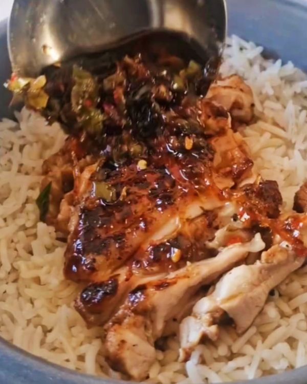 Step 2.1: Transfer the cooked chicken thighs to a serving plate and drizzle with chili oil for an extra kick of heat and flavor