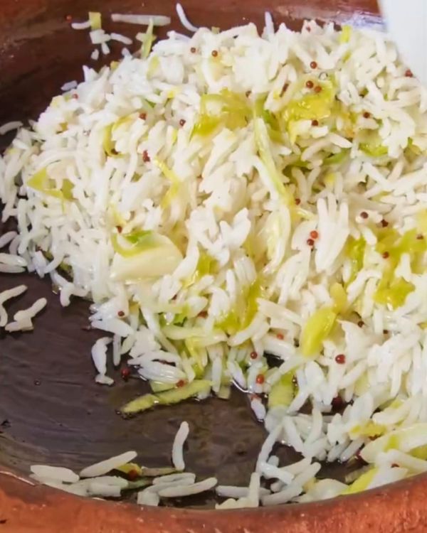 Step 1.1: Add the cooked rice to the skillet with the caramelized leek and garlic