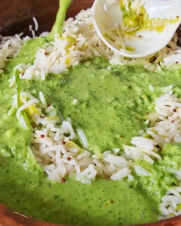 Step 2.1: Pour the prepared cilantro sauce over the rice, tossing gently to coat the grains evenly