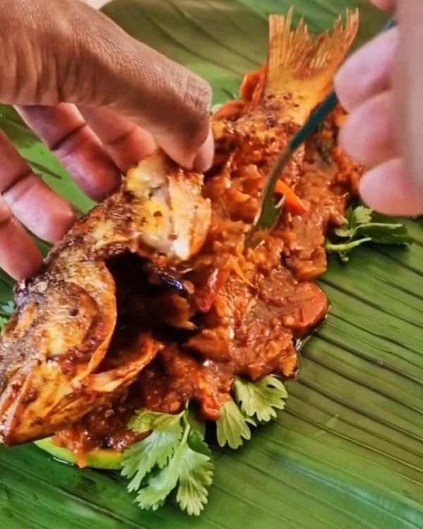Step 4.1: Stuff the masala filling into the scored cuts and cavity of the fish