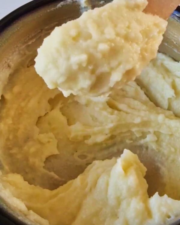 Step 3.1: Mash the scooped-out potato flesh with cheddar cheese, salt, and pepper