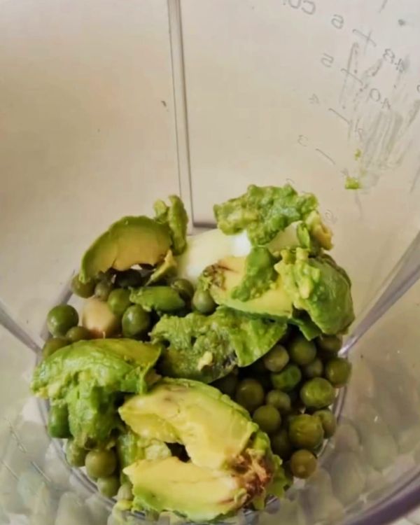 Step 2.1: In a blender, combine olive oil, white wine vinegar, coconut milk, garlic cloves, quartered onion, peas, avocado, coriander, chili flakes, lemon juice, and salt