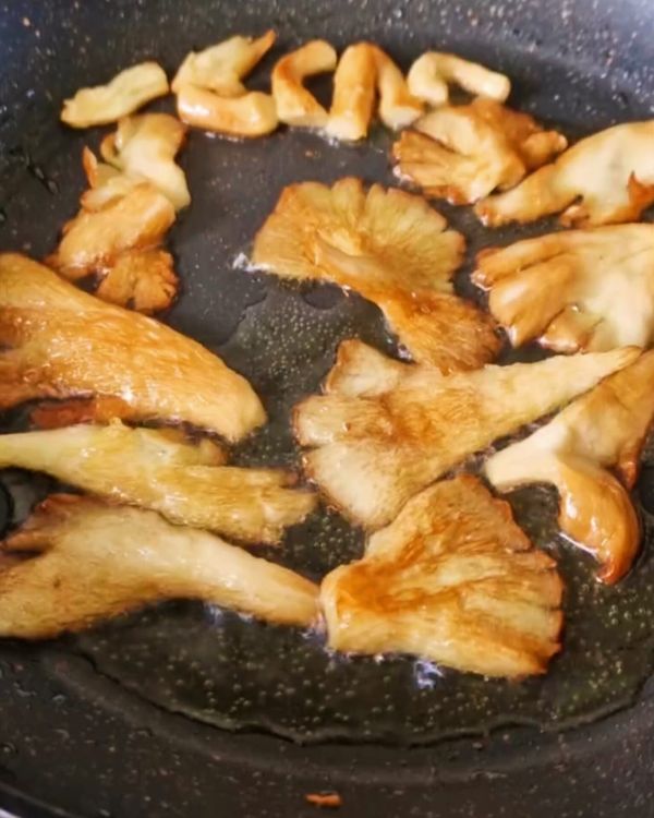 Step 3.1: Add the shredded oyster mushrooms and fry for 2-3 minutes until golden brown