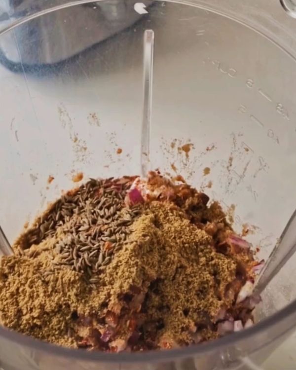 Step 2.1: Mix in cumin, coriander, turmeric, chili flakes, garlic, onion, salt, pepper, baking powder, and flour