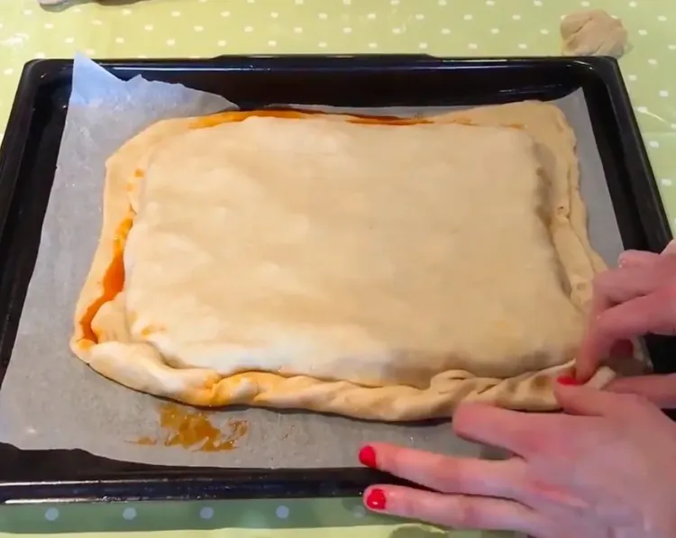 Step 3.1: Roll out half of the dough to make the base and place it in a baking tray
