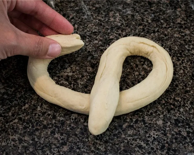 Step 2.1: Take one ball of dough and roll it out into a 22-inch rope using your hands
