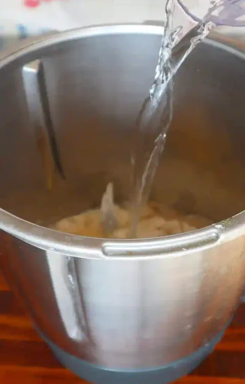 Step 2.1: Gradually add warm water to the dry ingredients while stirring until you achieve a smooth, pourable batter similar to pancake batter